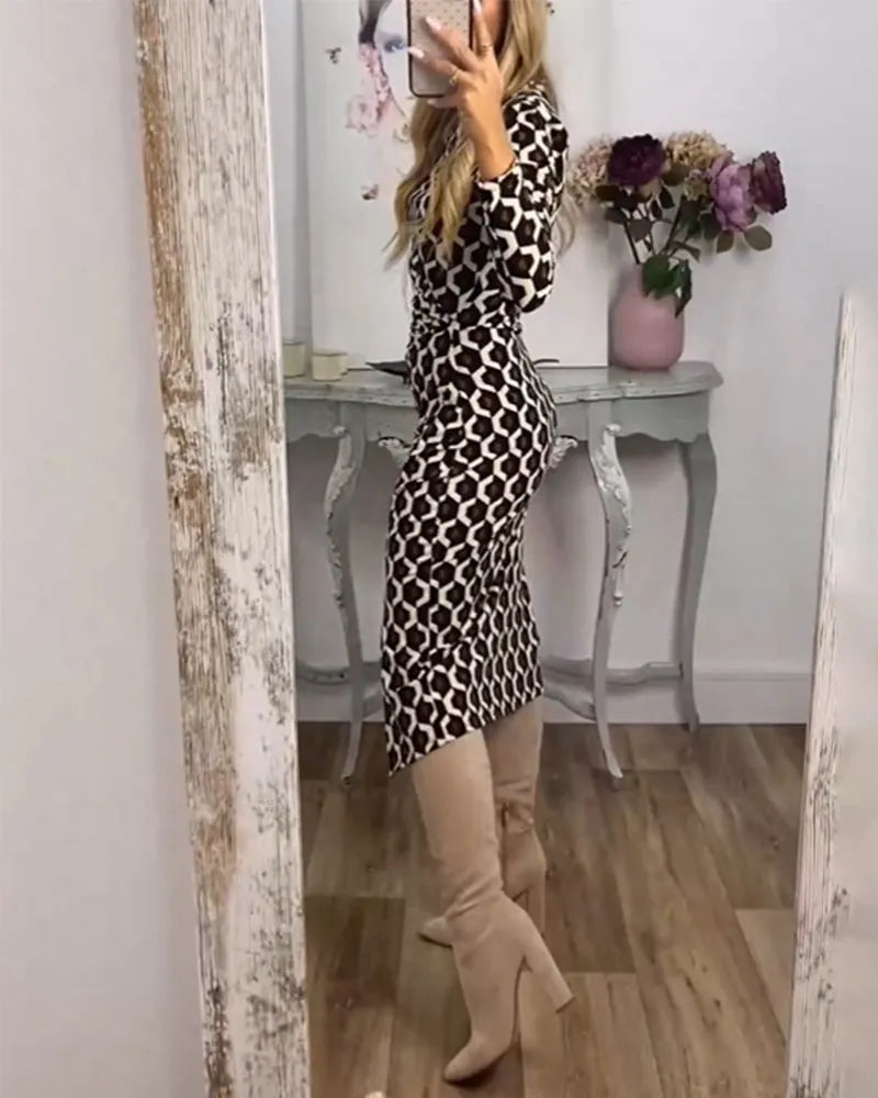 Modern women's midi dress with a striking geometric print, flattering ruching, and a chic high slit design.