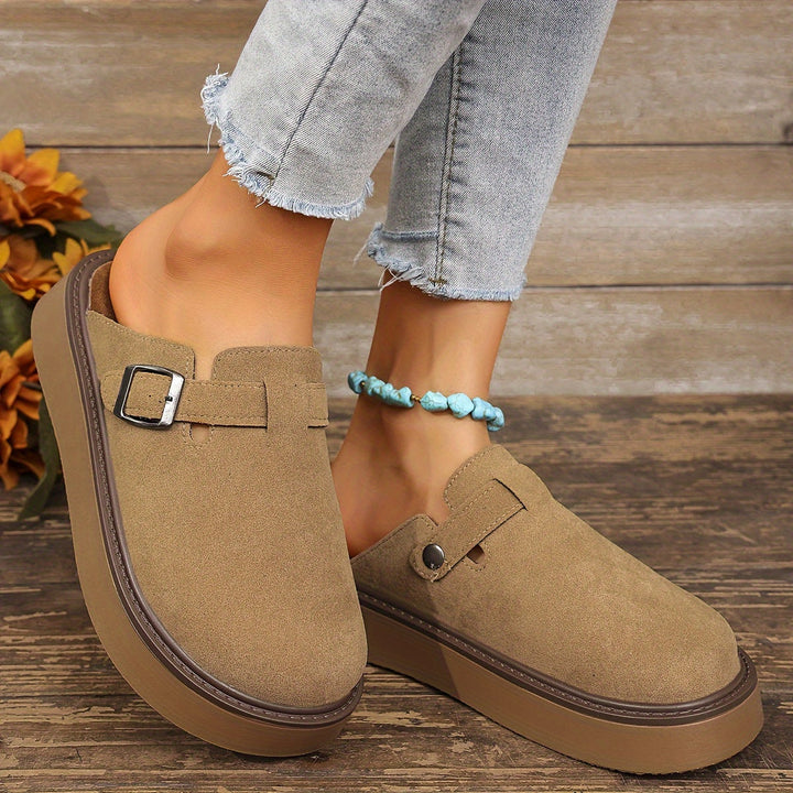Women's slip-on platform clogs, featuring an adjustable strap for a custom fit.