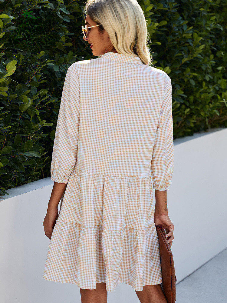 Women's elegant fall fashion: a high-neck checkered midi cardigan dress, blending style with warmth.
