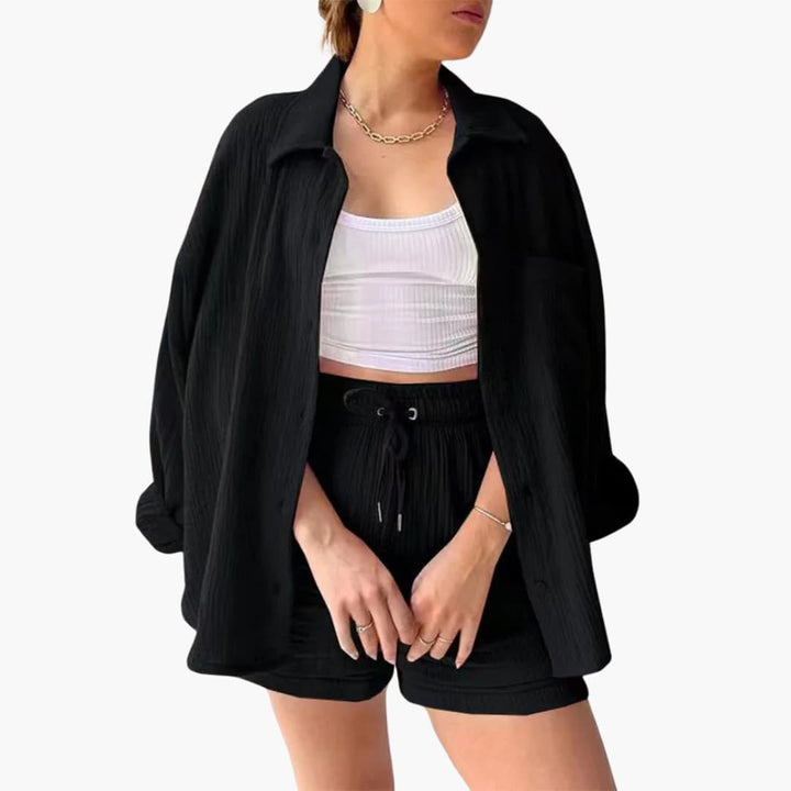 Stylish women's three-piece matching set featuring a button-up shirt, a crop top, and comfortable shorts. Chic.
