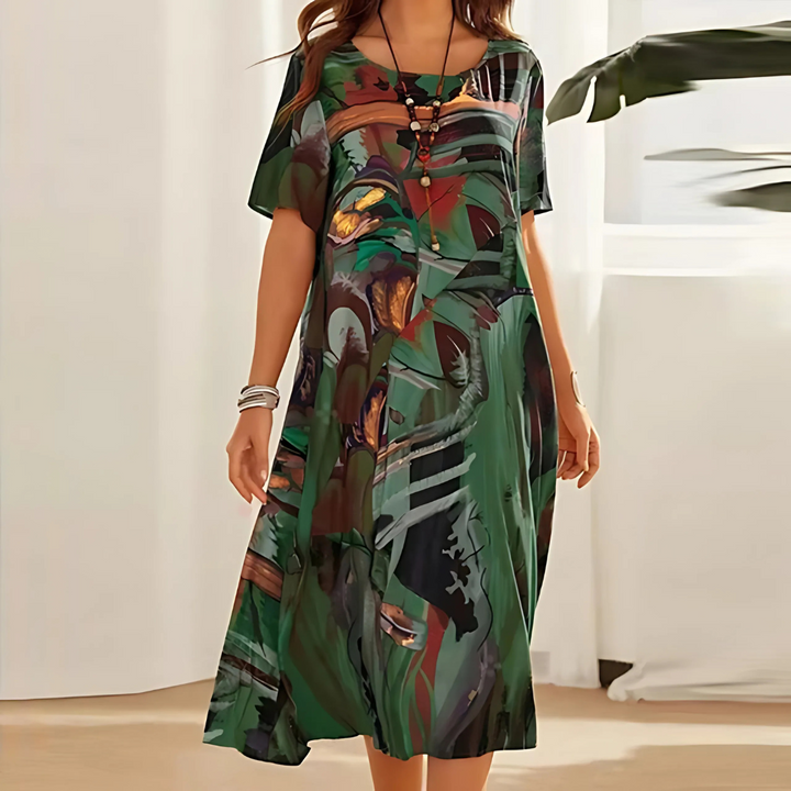 Flowy midi dress for women featuring a bold abstract print. Comfortable casual summer wear, round neck.
