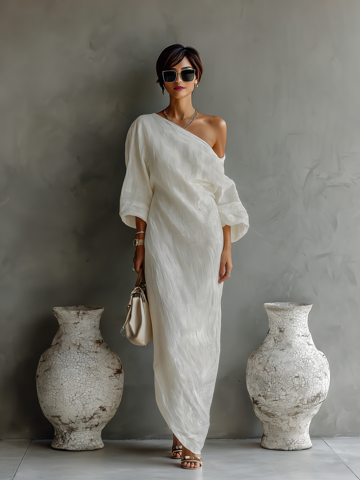 Fashionable women's one-shoulder party dress. Elegant ivory flowing maxi gown, suitable for formal events.