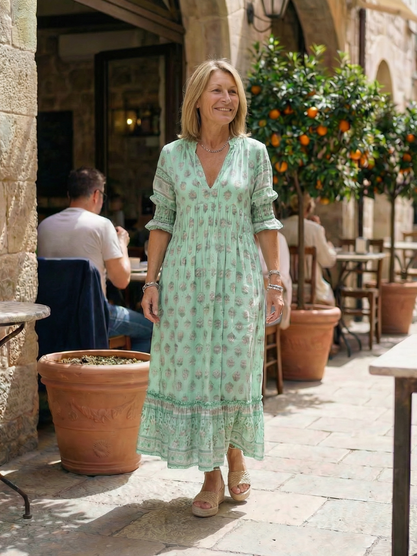 Chic floral print midi dress with a flattering V-neck & relaxed fit. Essential women's casual wear for spring.