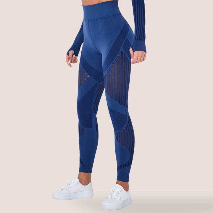 Woman modeling violet high-waist anti-cellulite leggings, stylish & comfortable activewear.