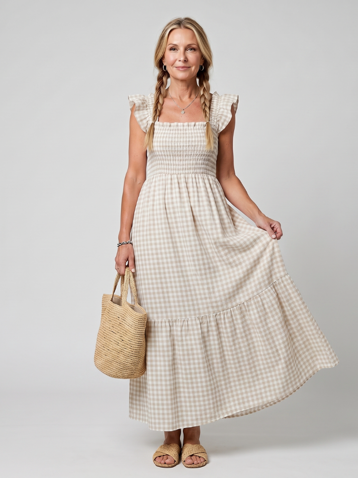 Flowy smocked gingham midi dress for women, sleeveless, with a modern square neck design.
