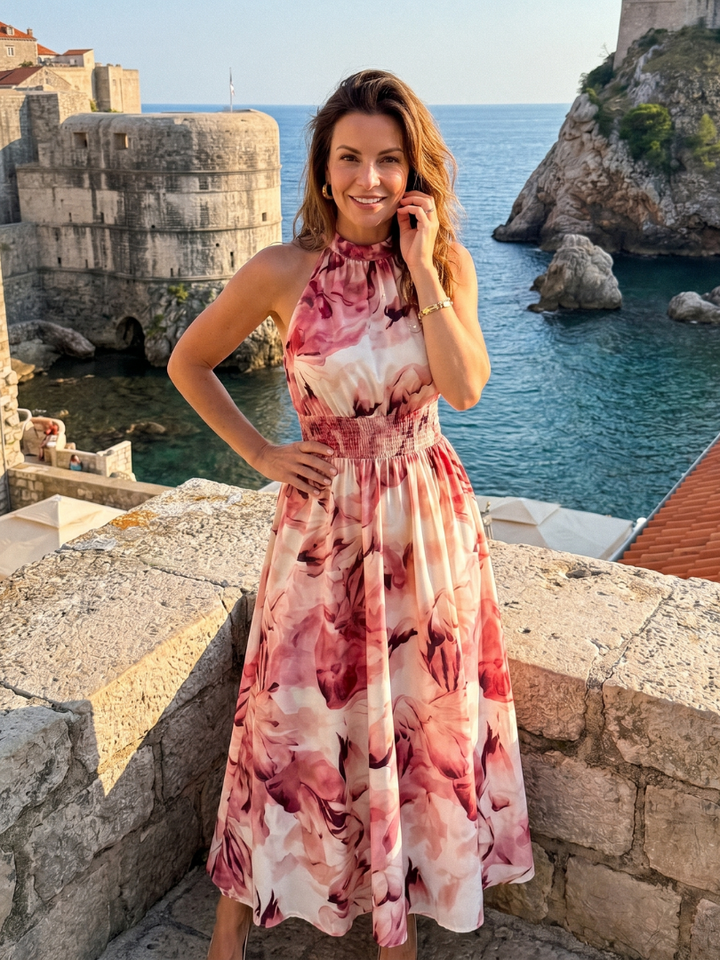 Vibrant abstract print women's midi dress, comfortable gathered waist. Perfect for a casual or elegant summer outing.
