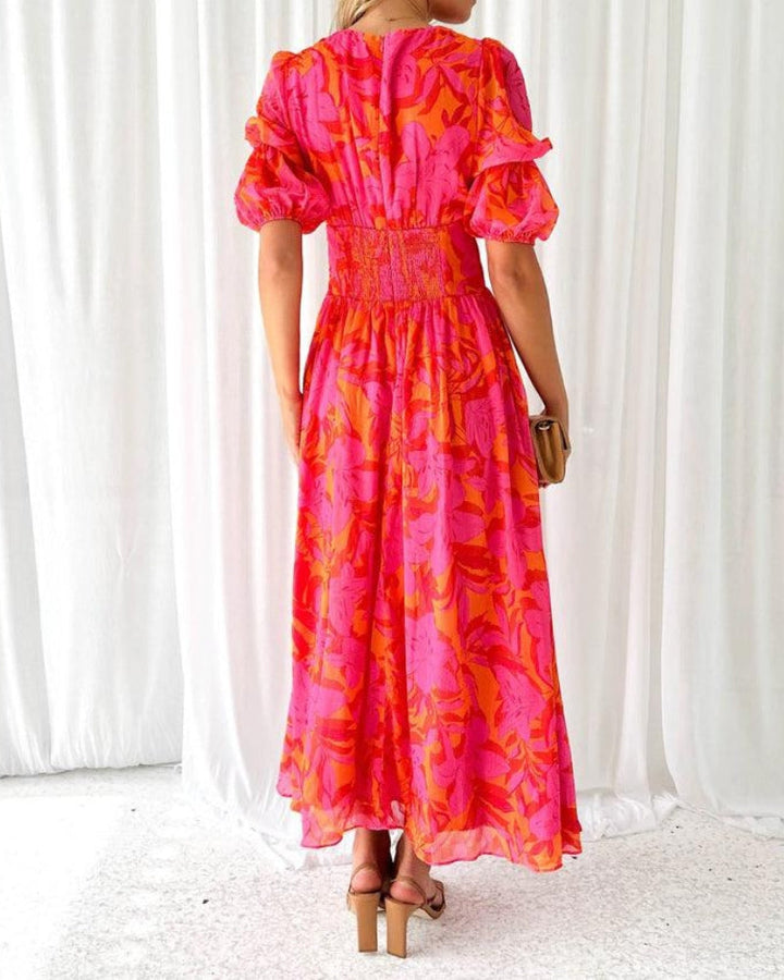 Long Women's V-Neck Maxi Dress with puffed sleeves, vibrant print, and flowing elegant design for summer wear.