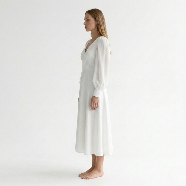 Versatile white V-neck wrap dress for women, midi length with a beautiful flared hem, combines comfort & style.