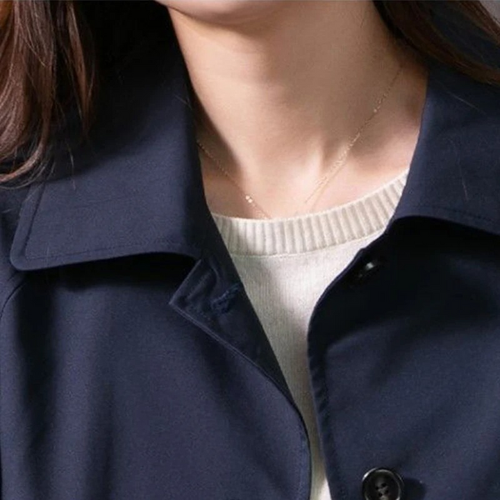 Fashionable women's classic trench coat, a chic long jacket with an adjustable tie-waist belt.