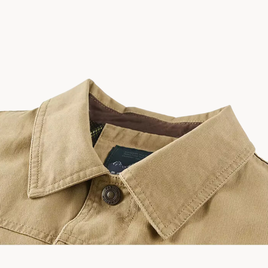 Front view of a dark gray men's durable utility cargo jacket, great for everyday adventure and casual wear.