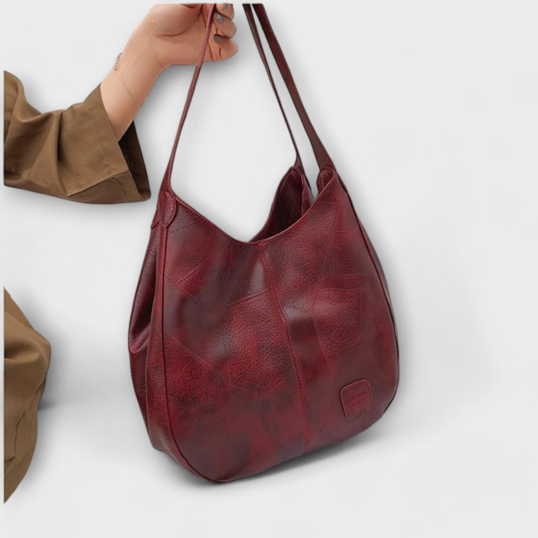 Retro-style brown leather shoulder bag for women, a classic vintage handbag accessory.