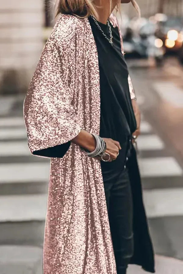 Women's chic sequined kimono, sparkling with dazzling elegance. Features a keyhole design and flowy bell sleeves.