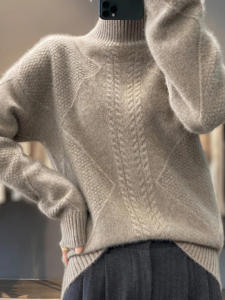 Close-up of a women's cashmere roll neck jumper, highlighting the intricate cable knit texture.
