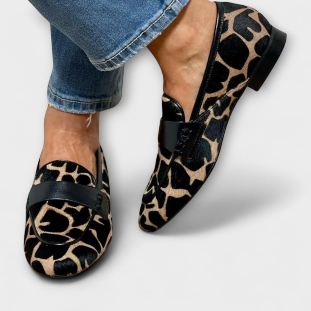 Elegant women's animal print loafers, perfect for dressy or casual wear. Comfortable slip-on design with a bold touch.