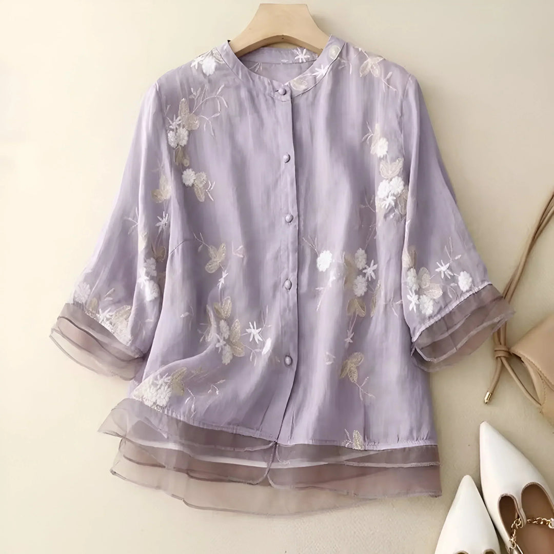 Stylish women's embroidered top with a tummy skimming design, perfect for versatile chic wear.
