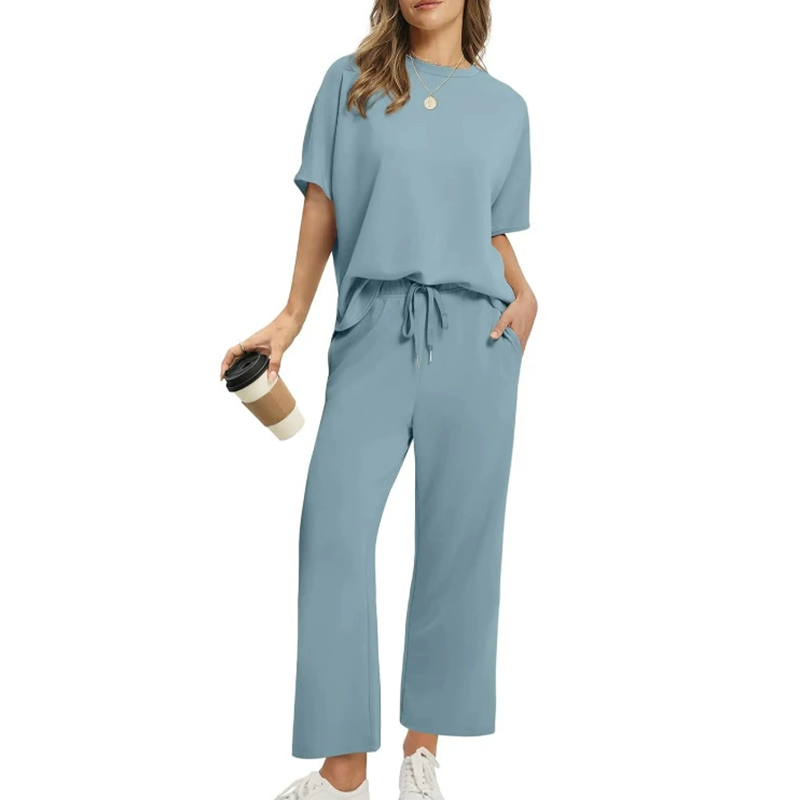 Casual women's ribbed two-piece set: round neck half-sleeve top & relaxed fit ankle trousers for ultimate comfort.