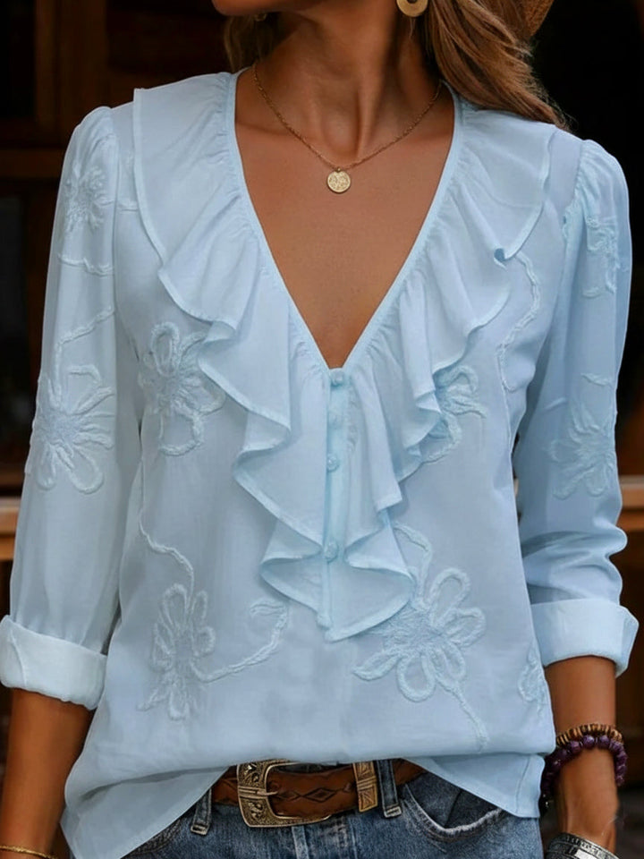 Elegant women's frill V-neck shirt in a beautiful vintage floral pattern, ideal for a refined look.