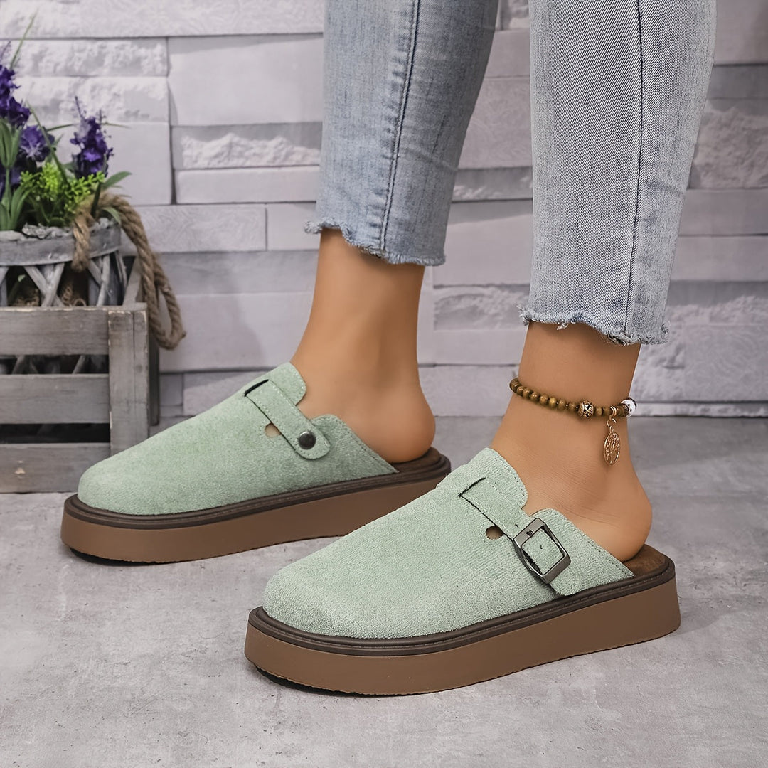 Durable women's platform walking clogs, featuring an adjustable strap for support.