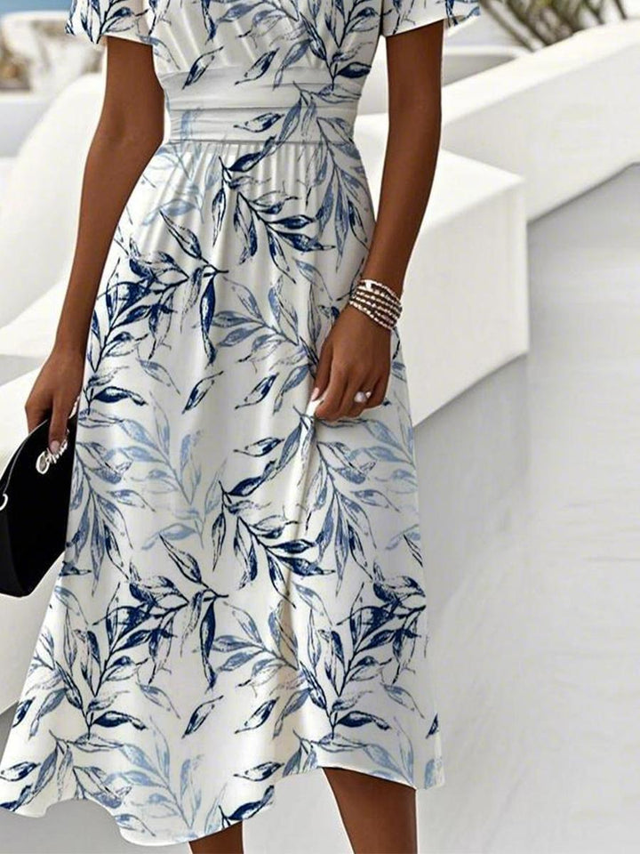 Stylish women's short sleeve V-neck wrap midi dress featuring a beautiful leaf print, ideal for smart casual wear.