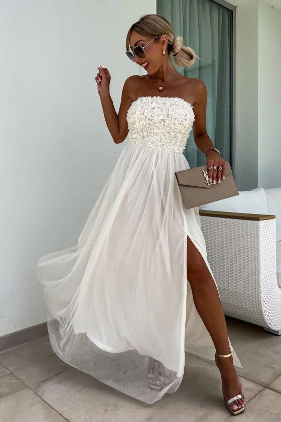 Chic white one-shoulder maxi dress with a head-turning high slit. Ideal for summer parties.