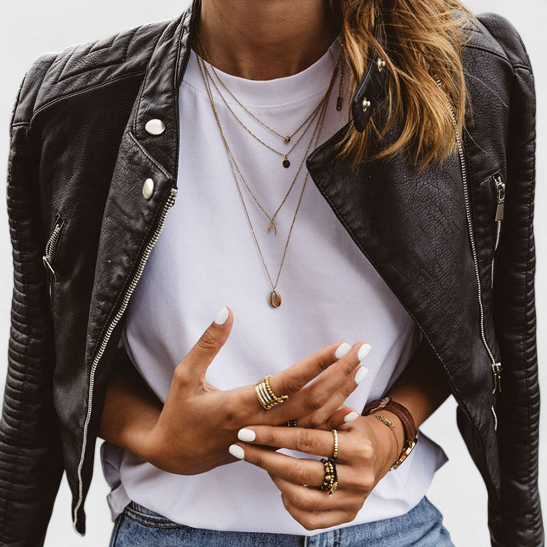 Trendy women's asymmetrical zipper jacket. Black long-sleeve fitted outerwear with a stylish stand collar for fashion.