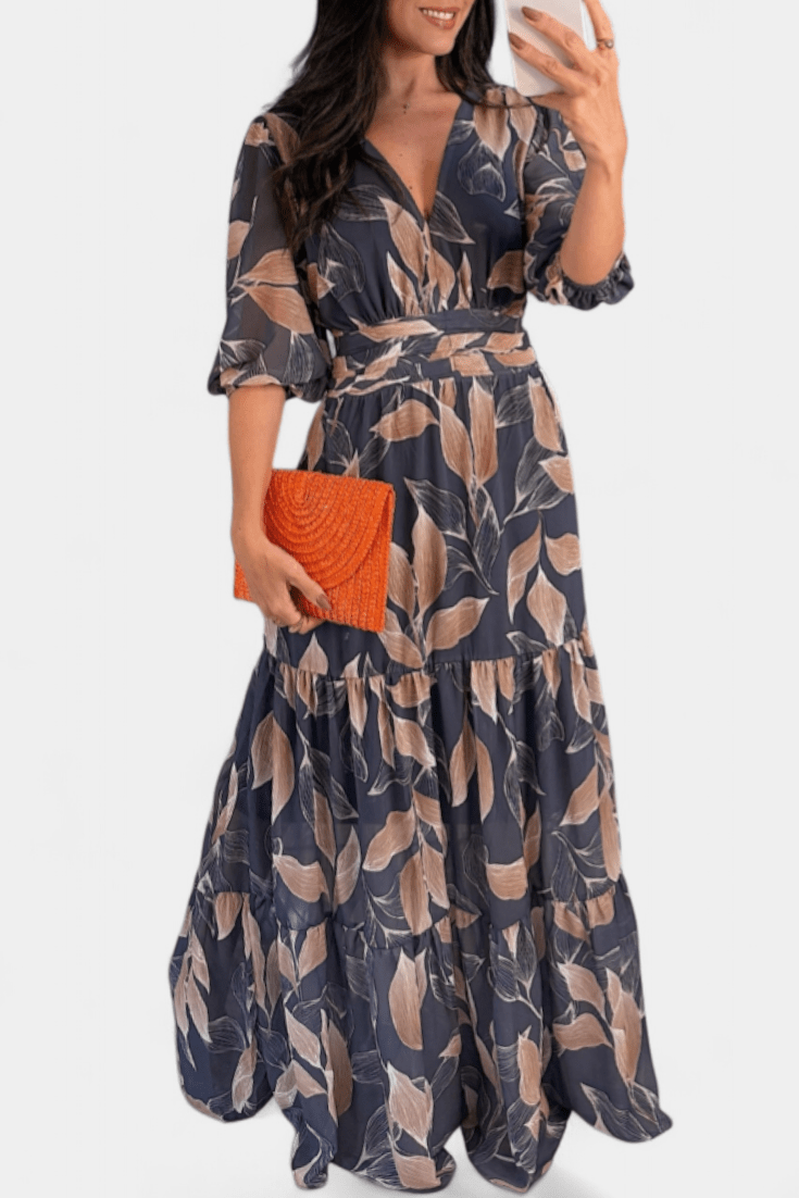 Feminine V-neck printed maxi dress for women, flowing silhouette. Elegant casual spring/summer outfit.