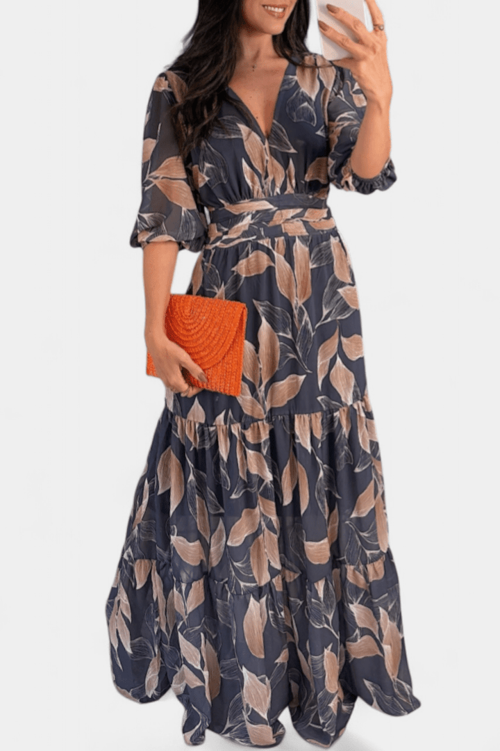 Feminine V-neck printed maxi dress for women, flowing silhouette. Elegant casual spring/summer outfit.