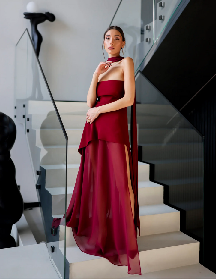 Close-up: Elegant, flowy fabric on a women's strapless maxi dress. Ideal for evening, summer & resort wear.