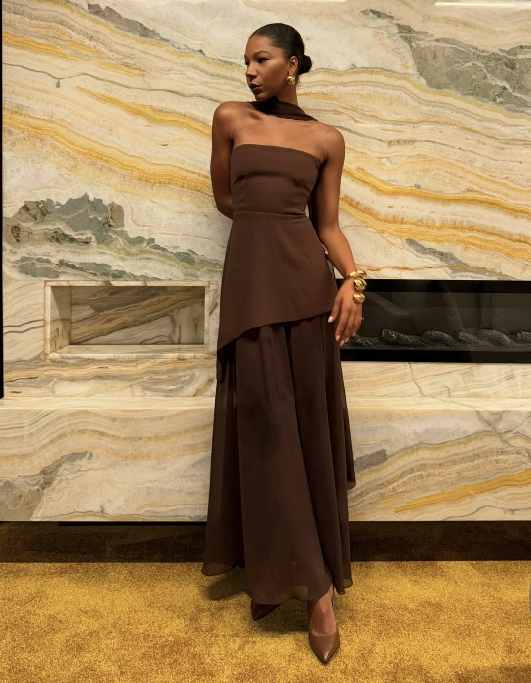 Elegant women's strapless maxi dress from the back, highlighting a sleek, seamless design for formal events.