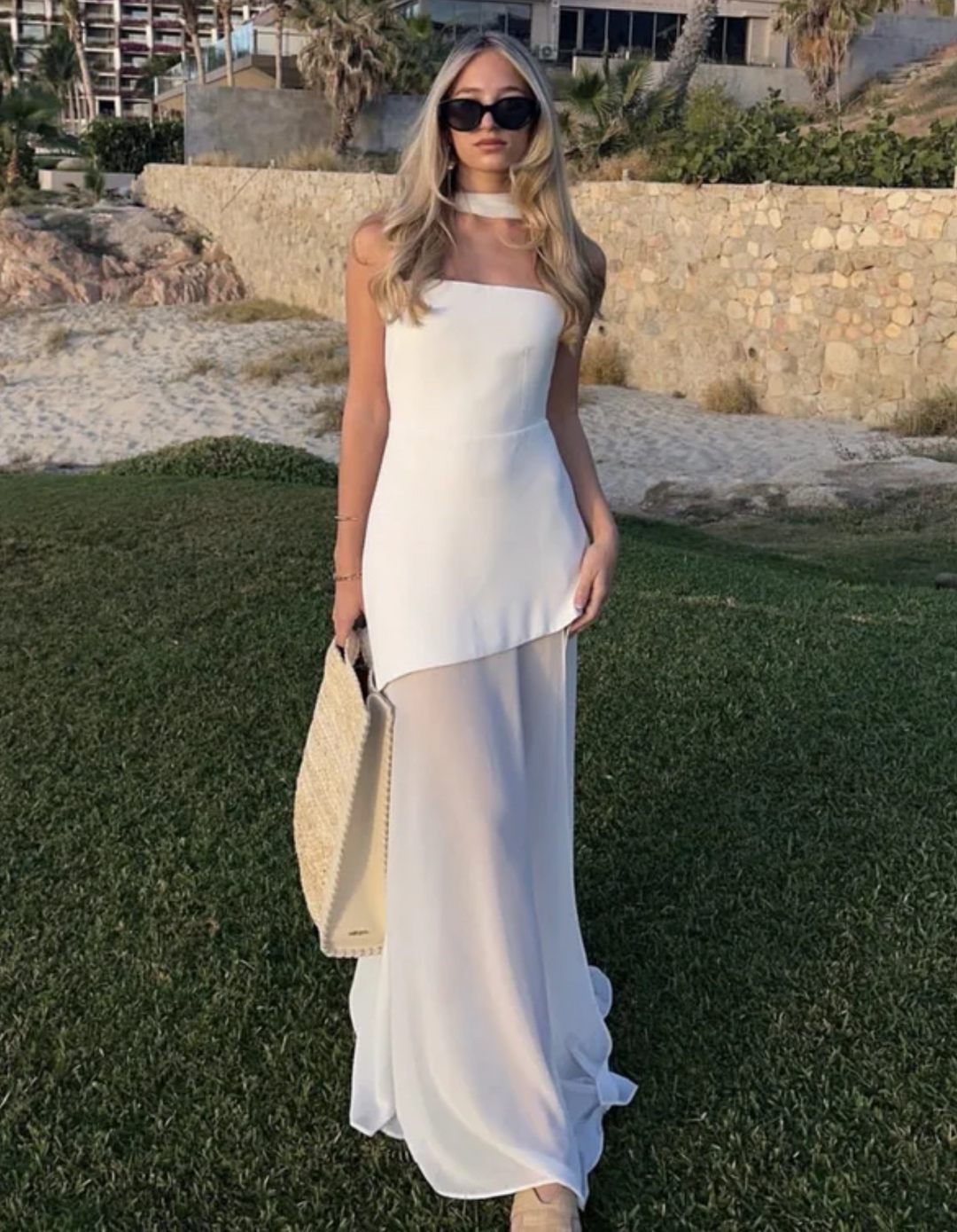 Long, flowy silhouette of an elegant women's strapless maxi dress, perfect for summer evenings & resort.