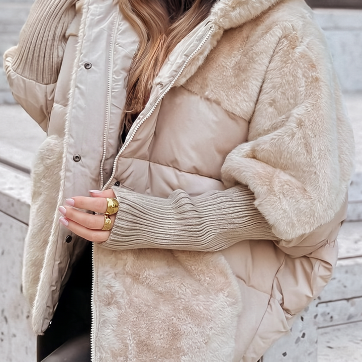 Elegant women's hooded padded winter coat, perfect for warmth and style in cold weather.