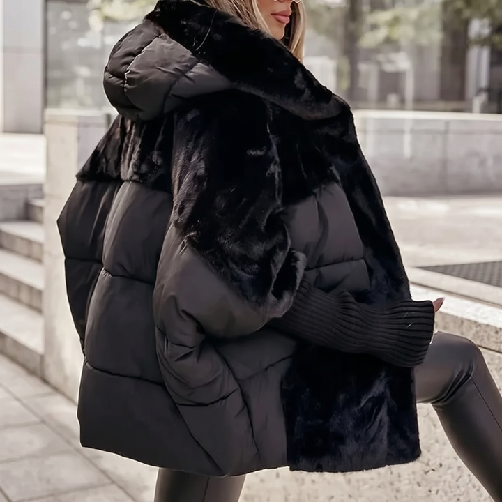Warm women's winter coat with hood, offering stylish and cozy protection from the cold.
