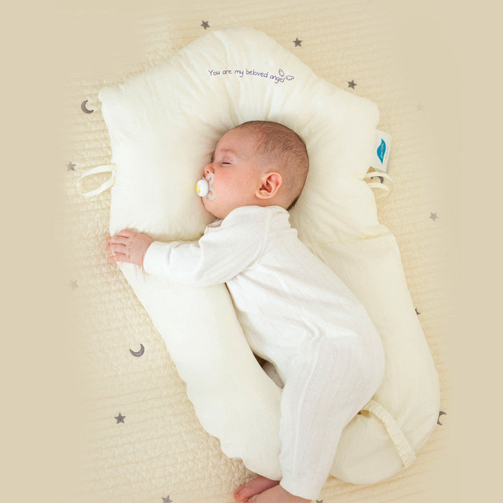 Ergonomic baby cuddle cushion provides safe, antibacterial sleep support for newborns and infants. Promotes comfort.