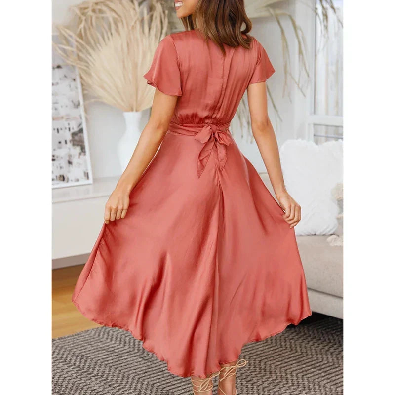 Stunning red women's midi dress, featuring an elegant and timeless design. Perfect for parties or relaxed outings.