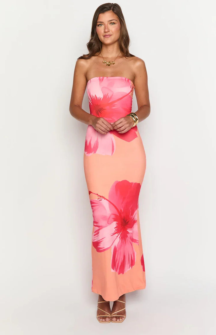Stylish women's flowy maxi dress with a vibrant floral pattern, ideal for vacation.