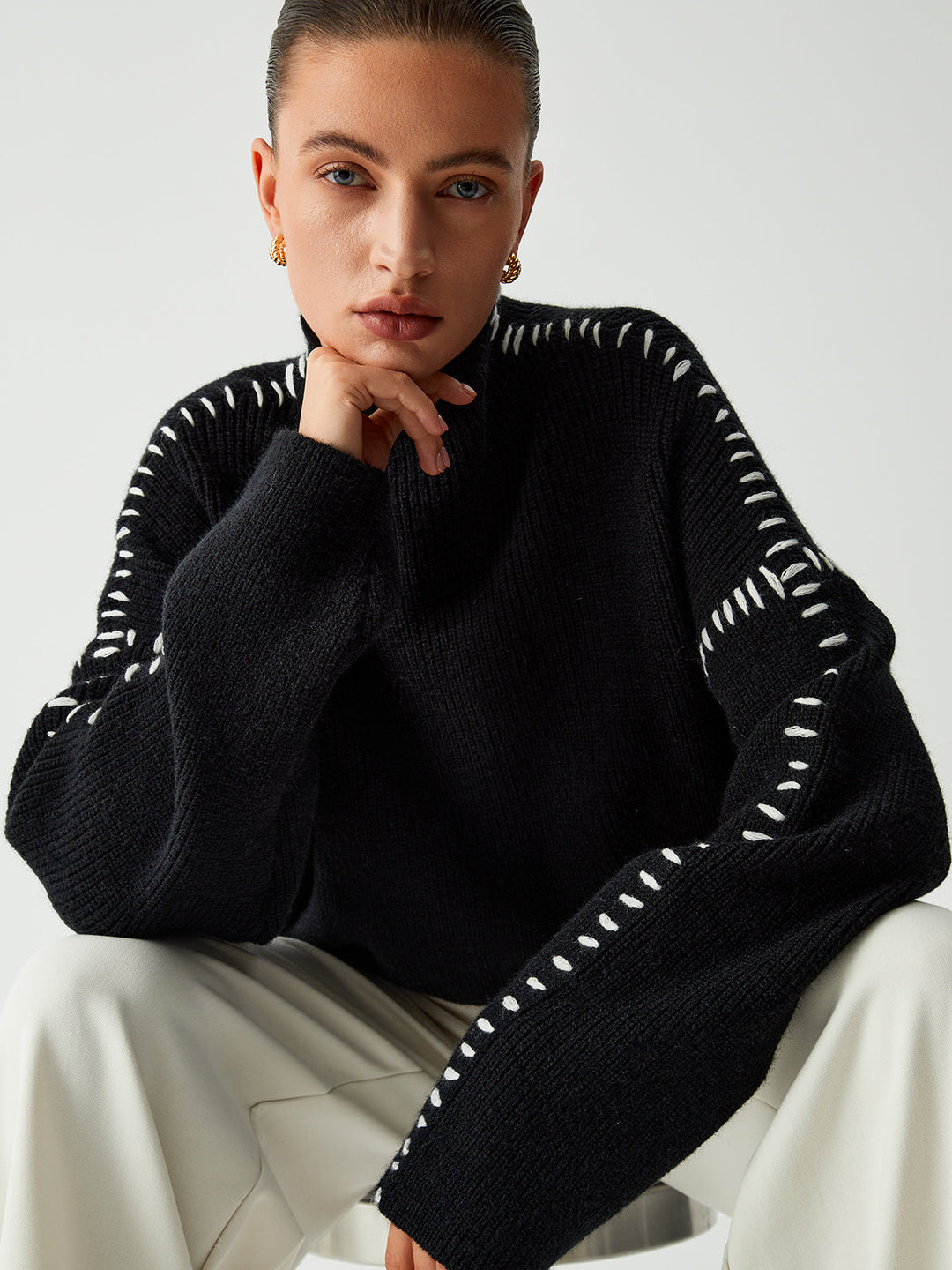 Stylish women's oversized mock neck jumper with elegant contrast stitching, great for casual winter wear.