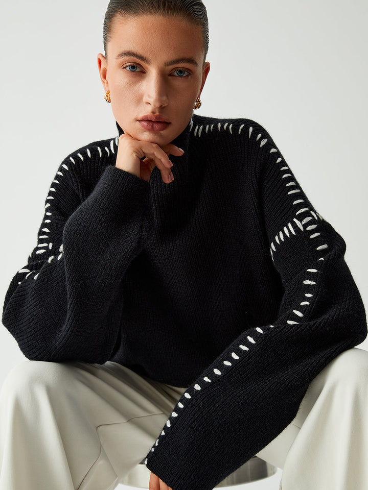 Stylish women's oversized mock neck jumper with elegant contrast stitching, great for casual winter wear.