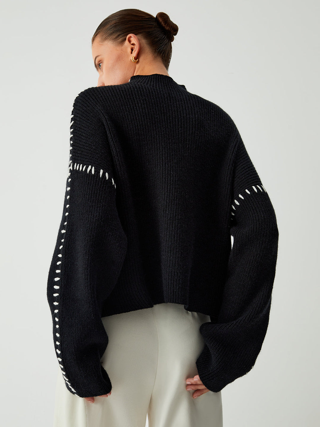 Relaxed fit women's oversized jumper with eye-catching contrast stitching, a must-have for winter fashion.