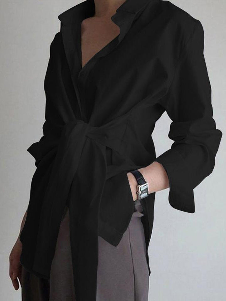Close-up of elegant women's tie-waist shirt, showcasing fabric and design for a polished look.