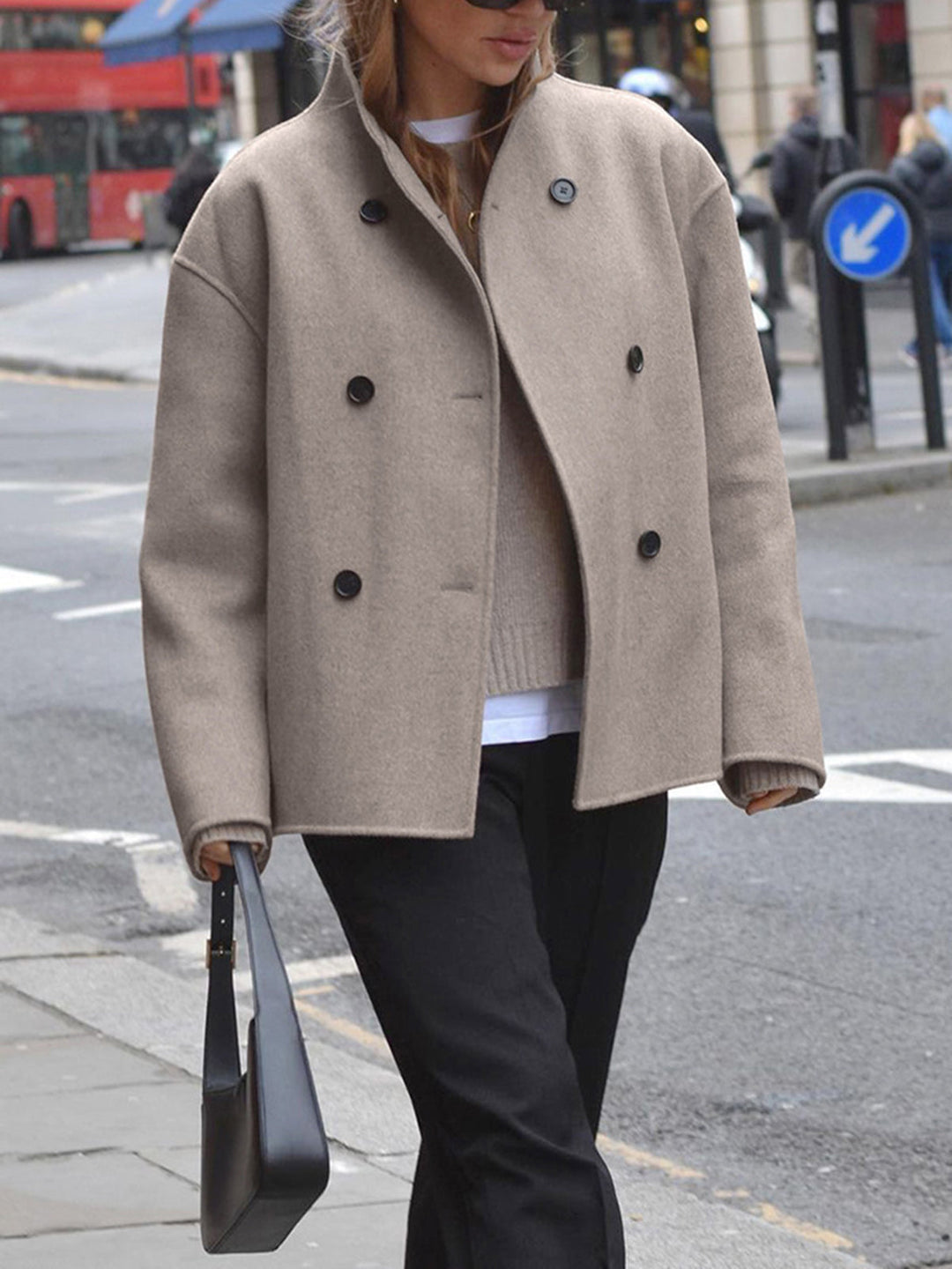 Stylish women's double-breasted pea coat. Classic winter jacket with stand collar for elegant warmth.