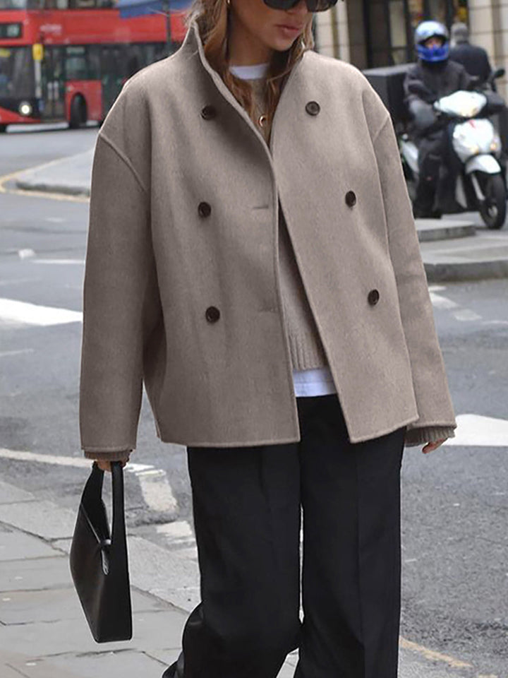 Women's double-breasted pea coat with elegant stand collar. Classic winter outerwear for warmth.