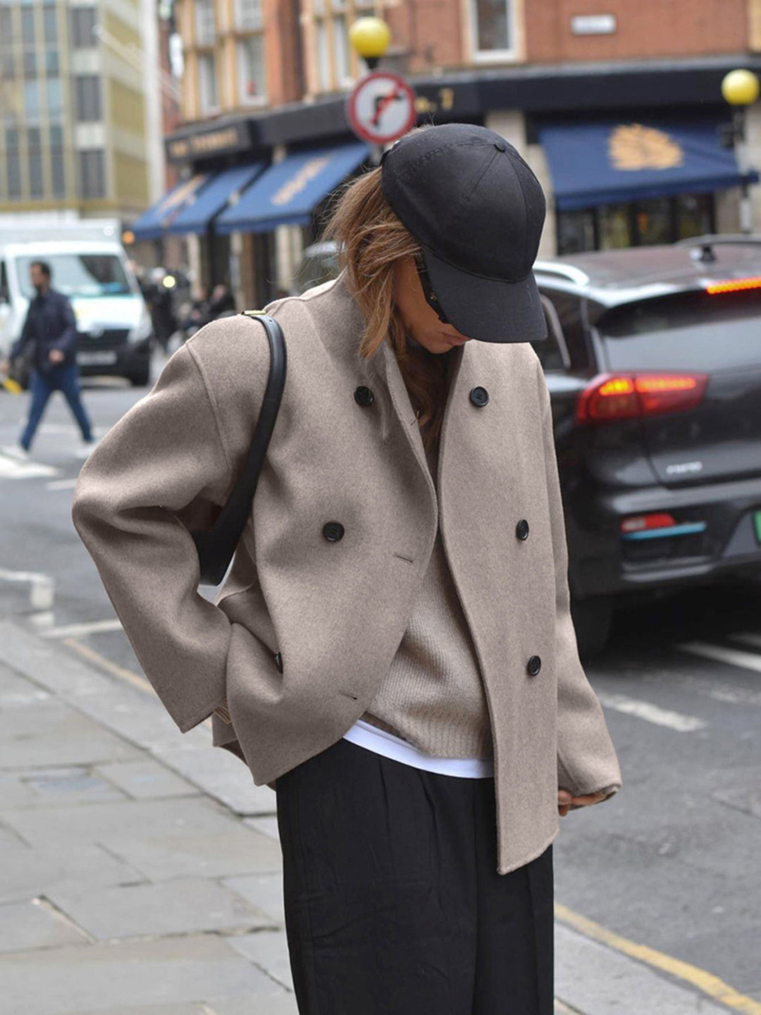 Relaxed fit women's pea coat, double-breasted design. Elegant winter jacket for stylish warmth.