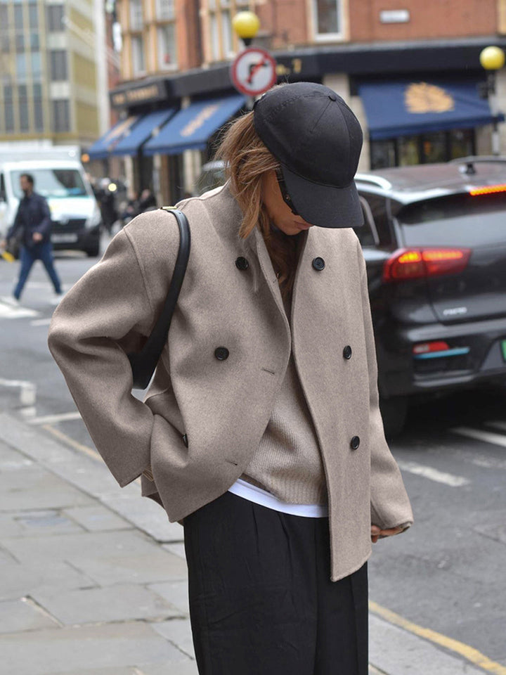 Relaxed fit women's pea coat, double-breasted design. Elegant winter jacket for stylish warmth.