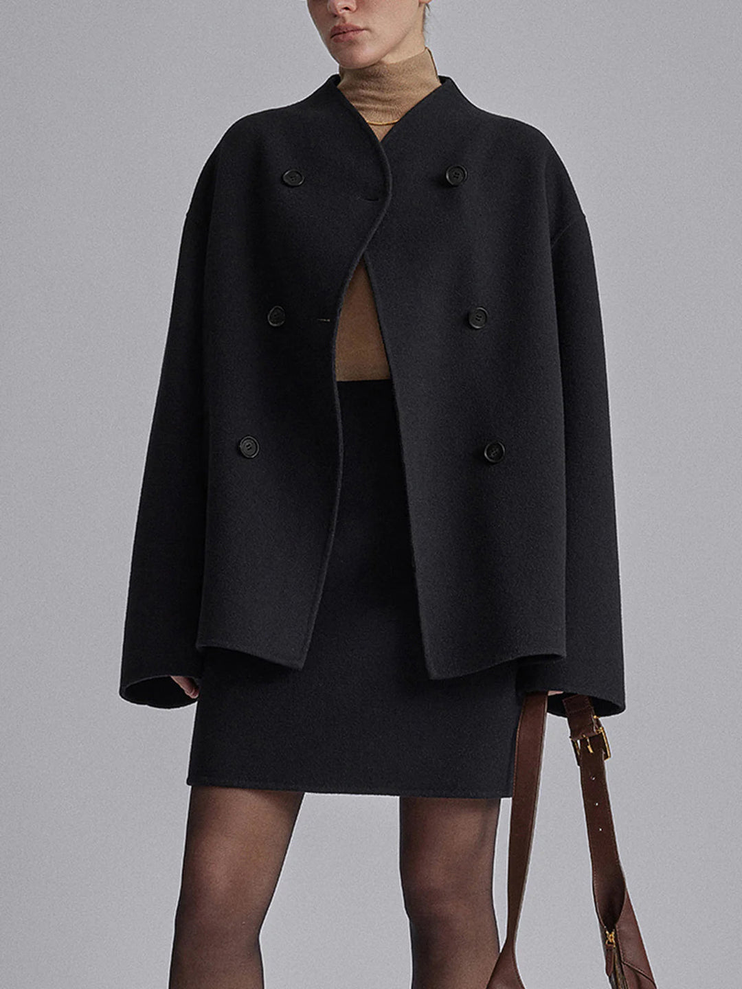 Elegant women's pea coat, double-breasted winter jacket. Classic outerwear with stand collar for warmth.