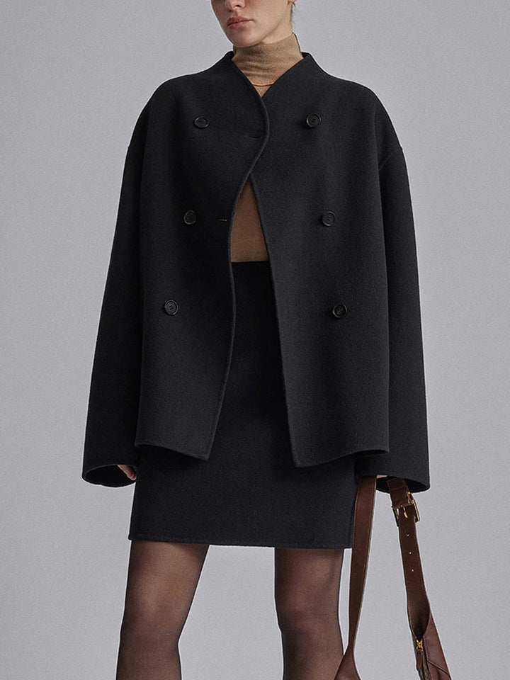 Elegant women's pea coat, double-breasted winter jacket. Classic outerwear with stand collar for warmth.