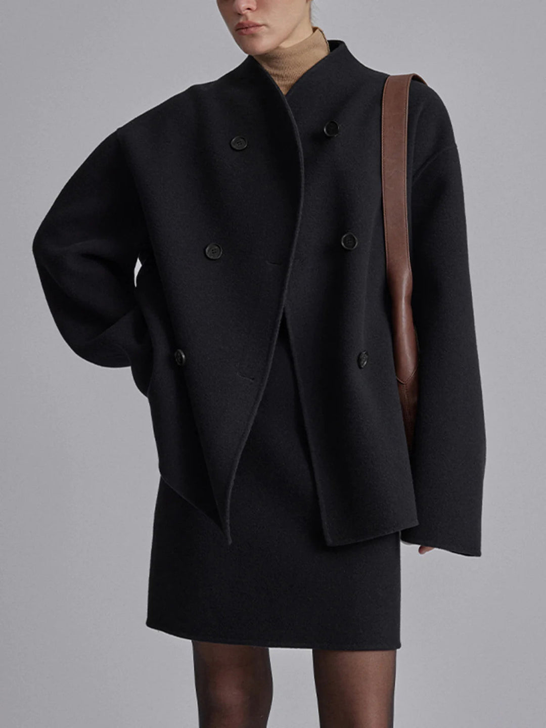 Full-length view of a women's double-breasted pea coat. Stylish winter outerwear, classic design, relaxed fit.