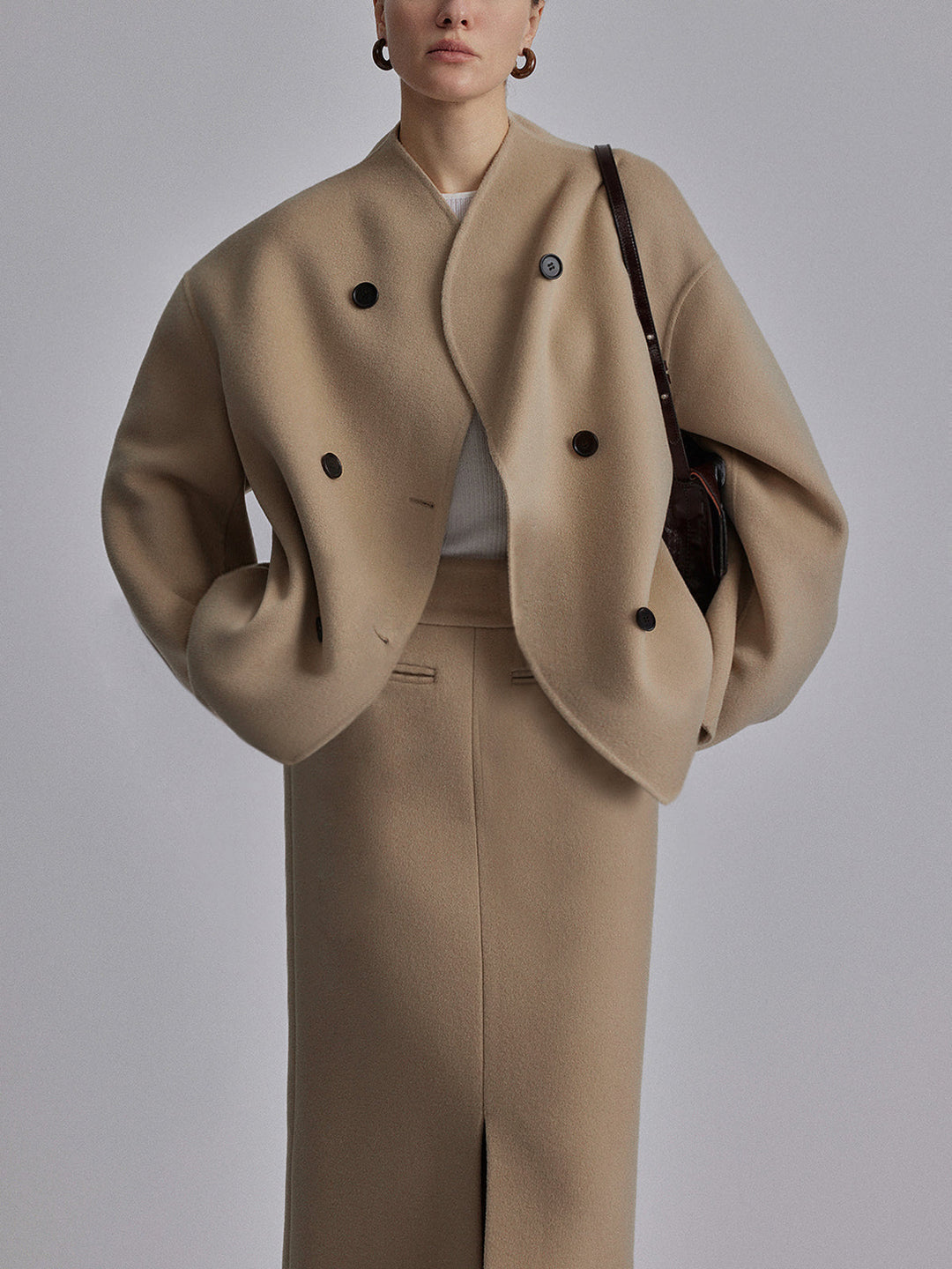 Detail of a women's double-breasted pea coat buttons and stand collar. Elegant classic winter jacket.