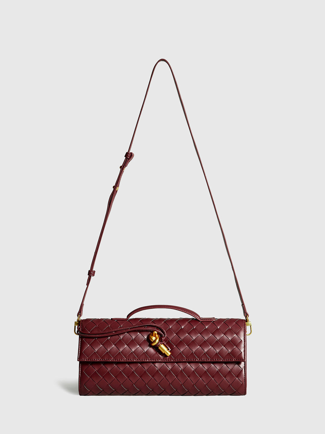 Women's versatile woven flap clutch bag in wine red. Converts to a stylish shoulder purse.