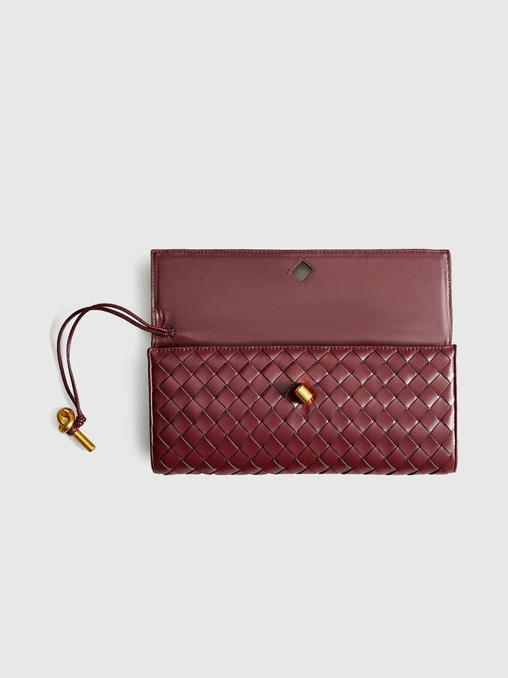 Elegant women's wine red woven handbag, a chic accessory for any evening or event.