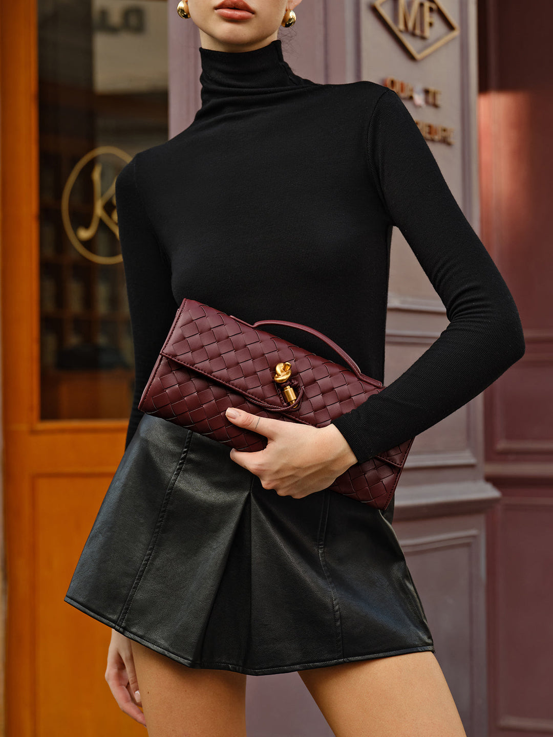 Stylish wine red woven handbag with flap closure and detachable strap. Ideal evening purse.